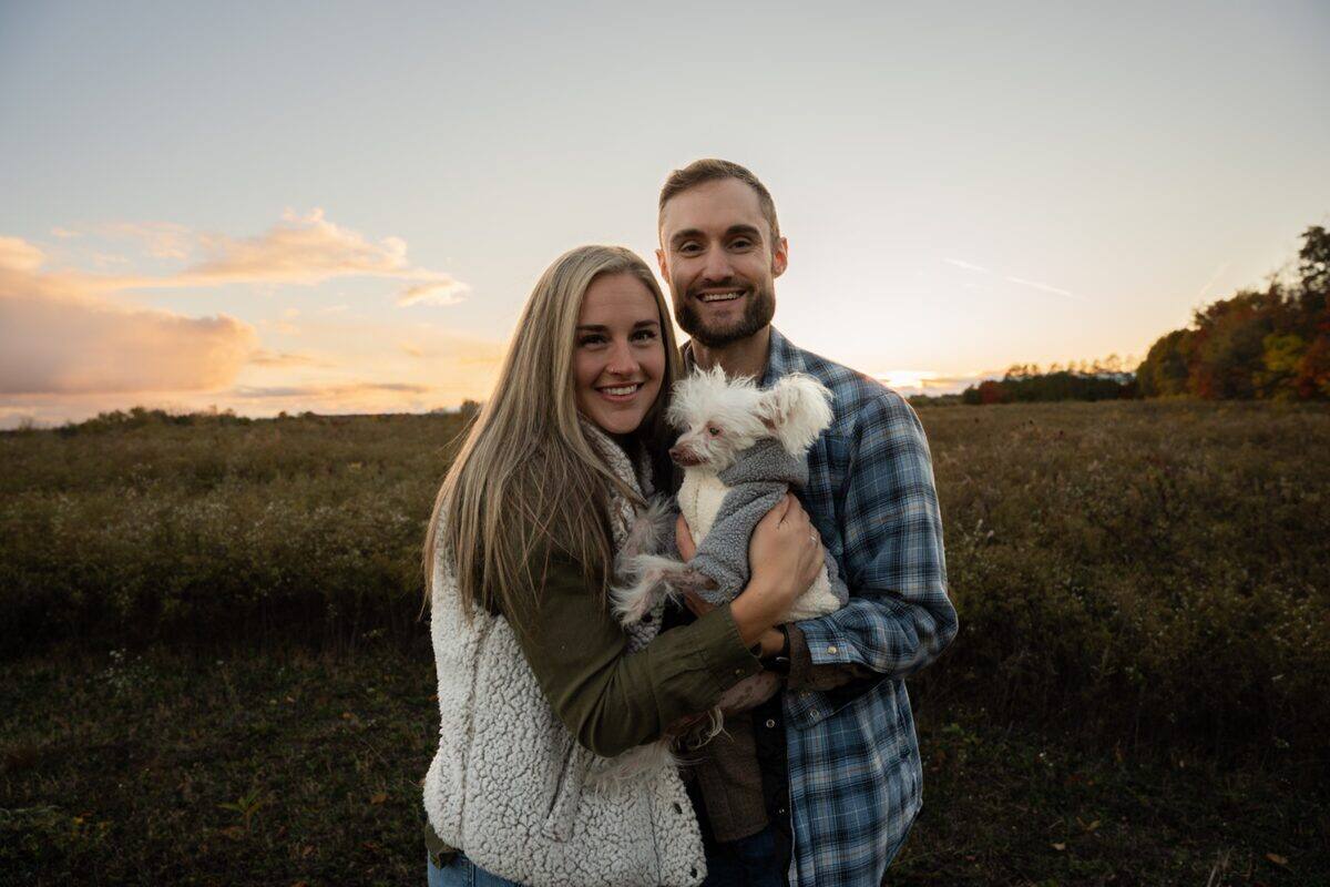 Couple with their dog at sunset