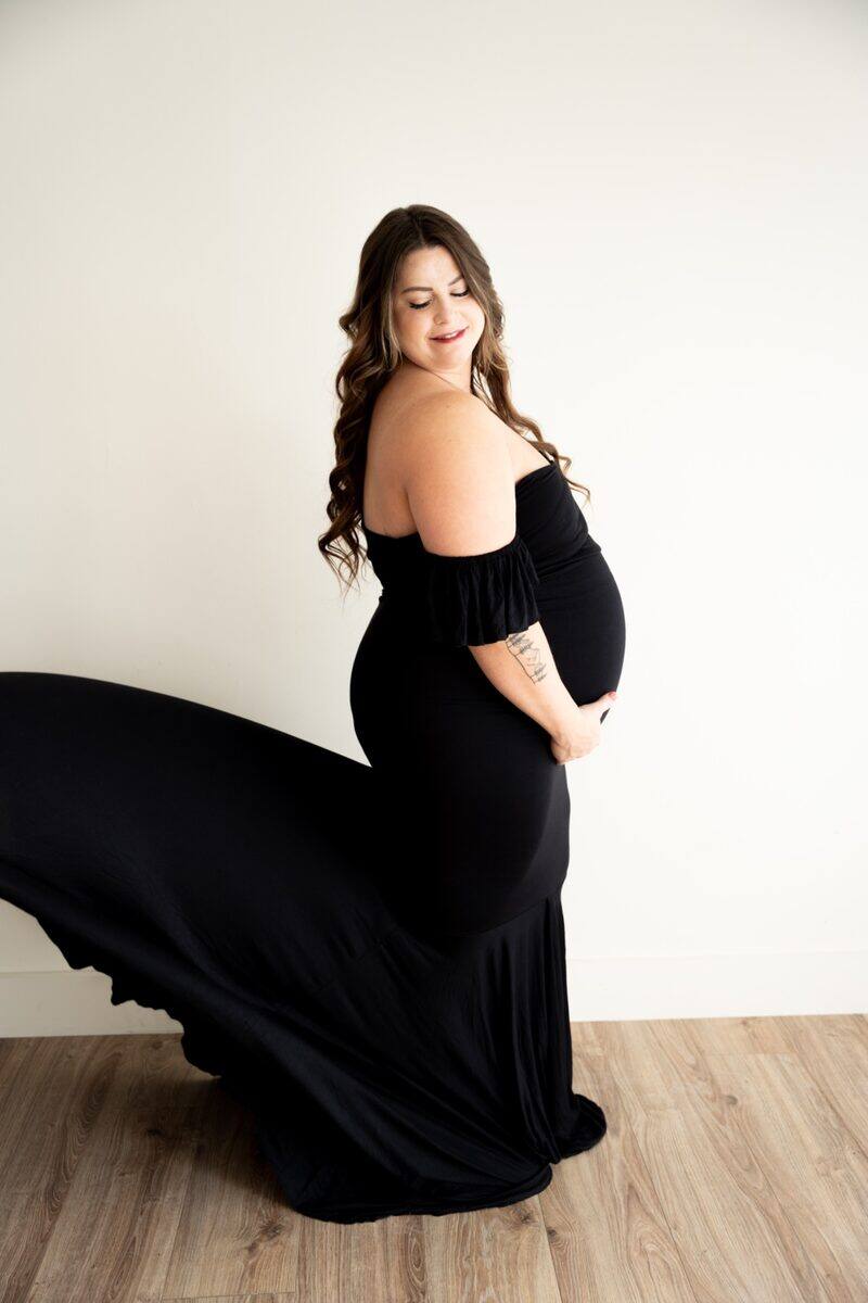 Studio maternity portrait in a flowing black gown