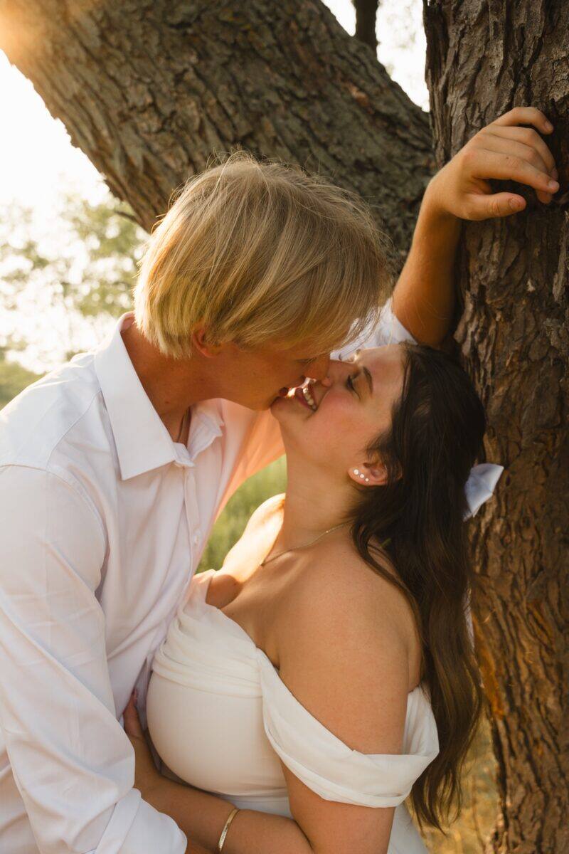 Maternity couple portrait beneath a tree
