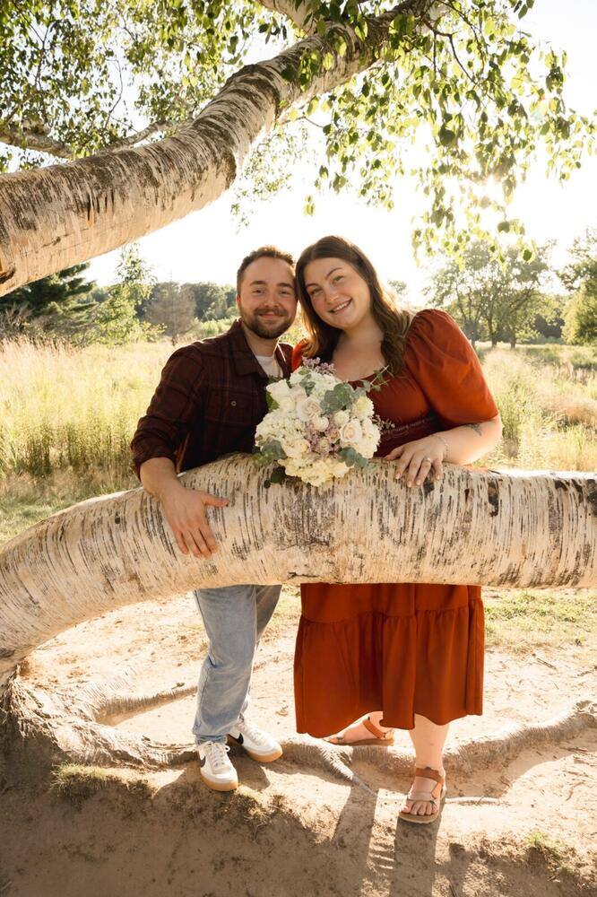 Happy engaged couple beneath a tree