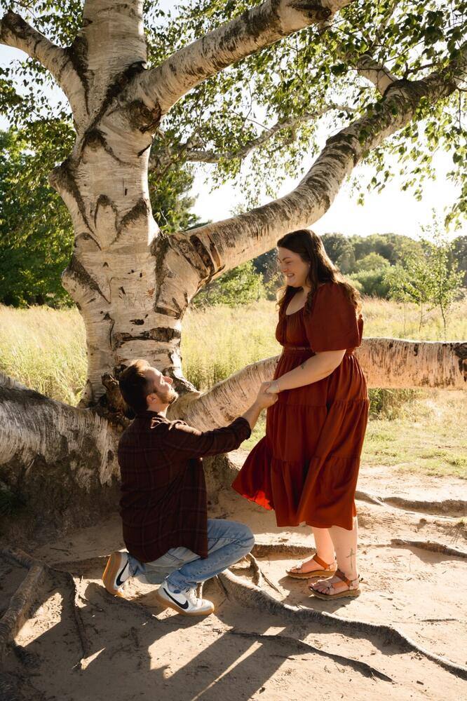 Surprise proposal beneath a tree