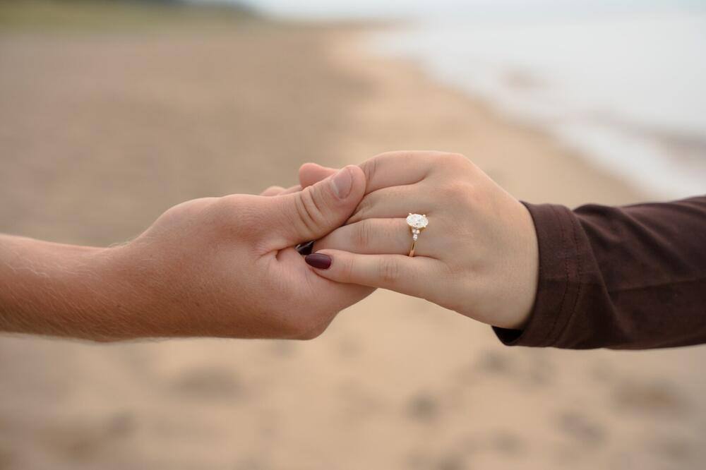 Couple showing an engagement ring