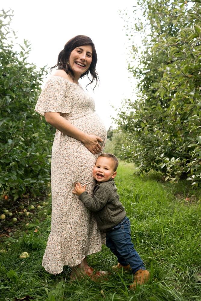Expecting mother with her young child