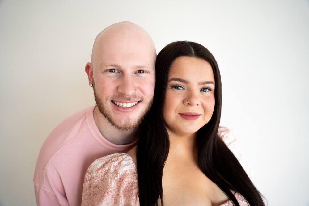 Expecting couple smiling in the studio