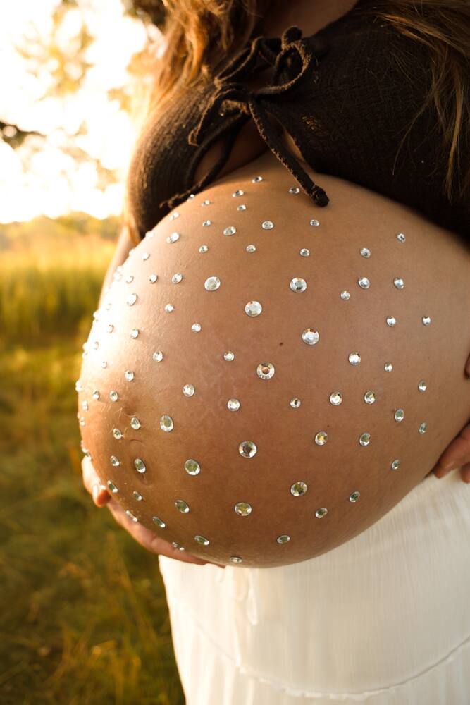 Jeweled baby bump detail portrait