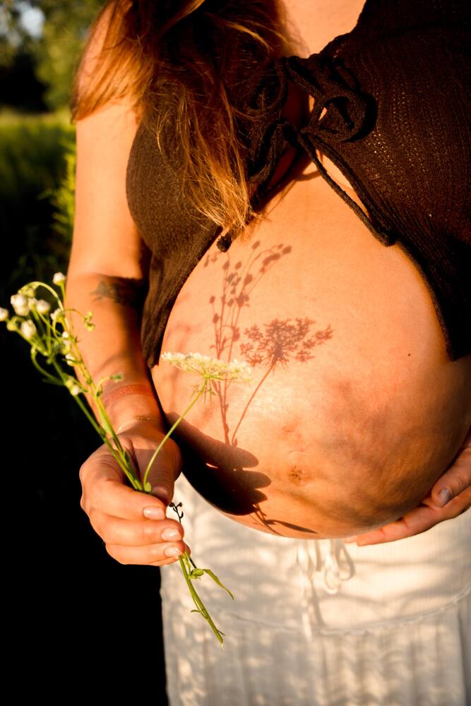 Sunlit maternity detail with a flower