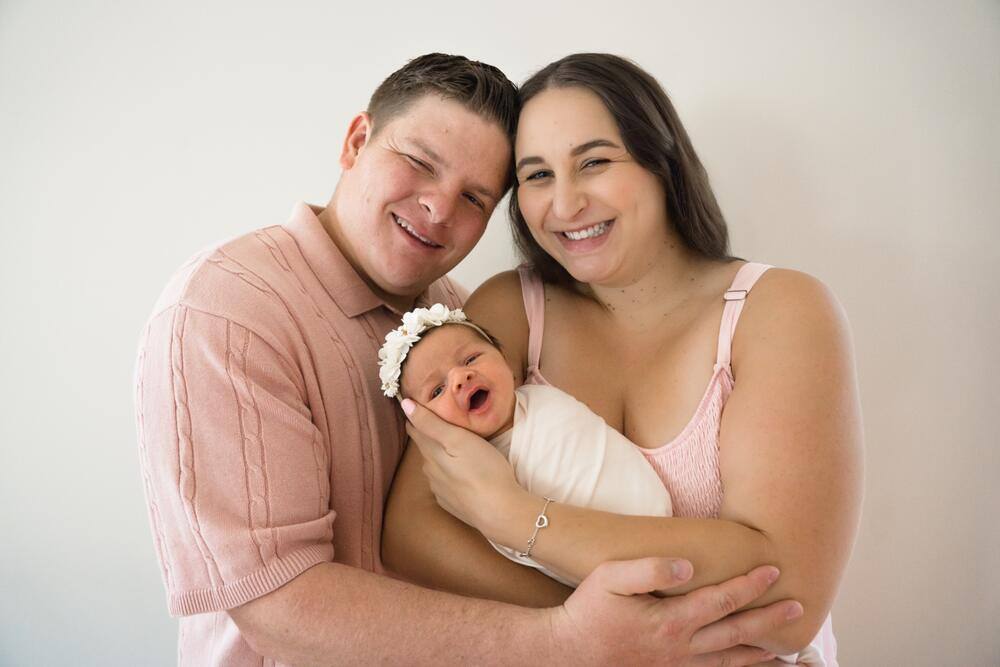 Parents smiling with their newborn