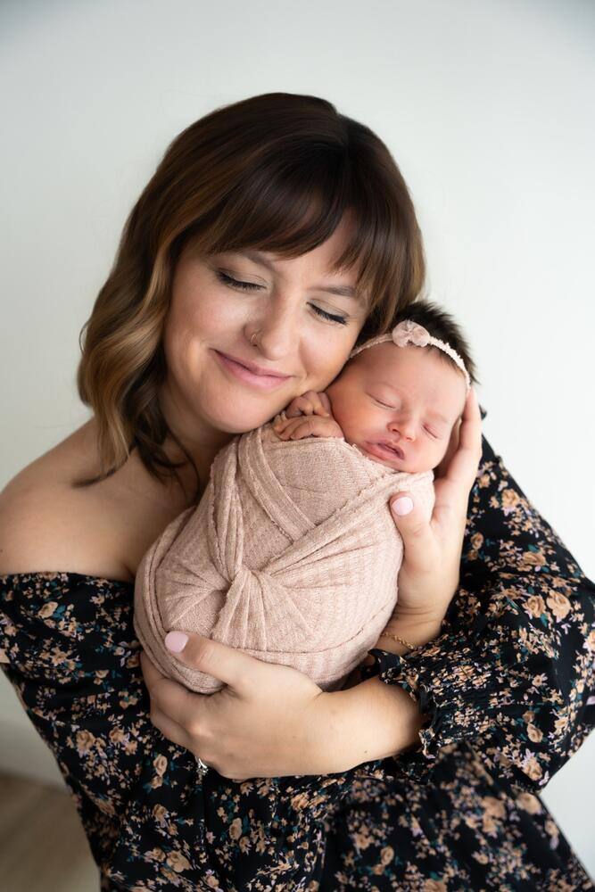 Mother holding her newborn close