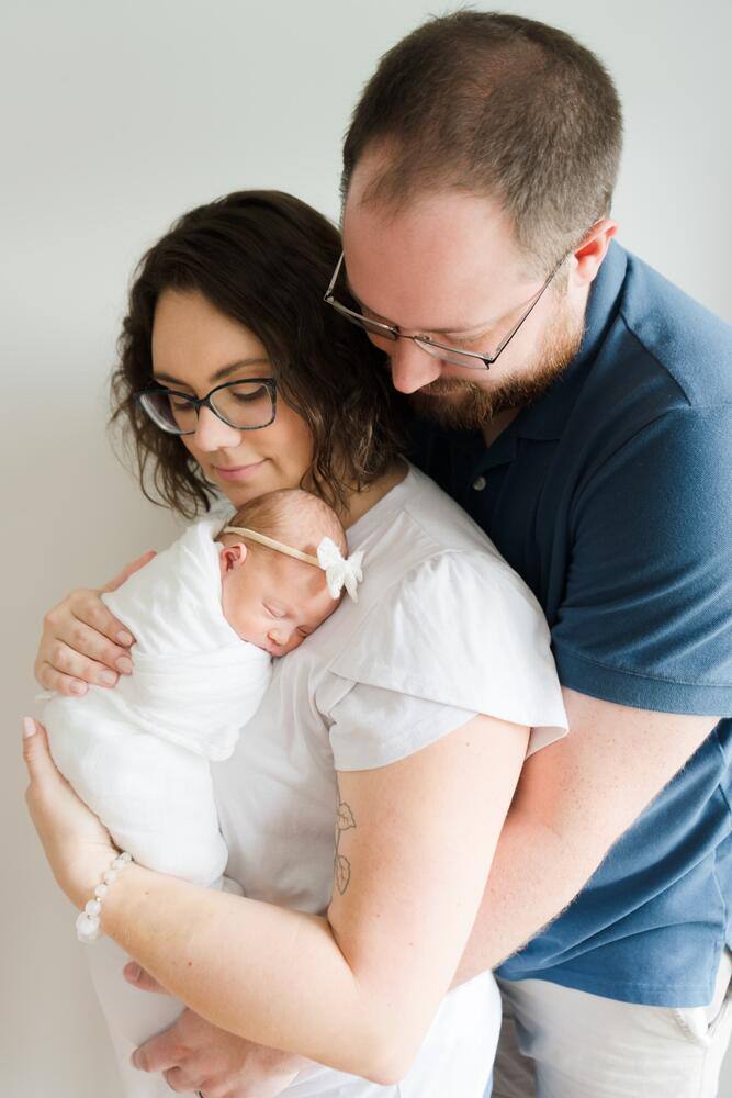 Parents cuddling their newborn