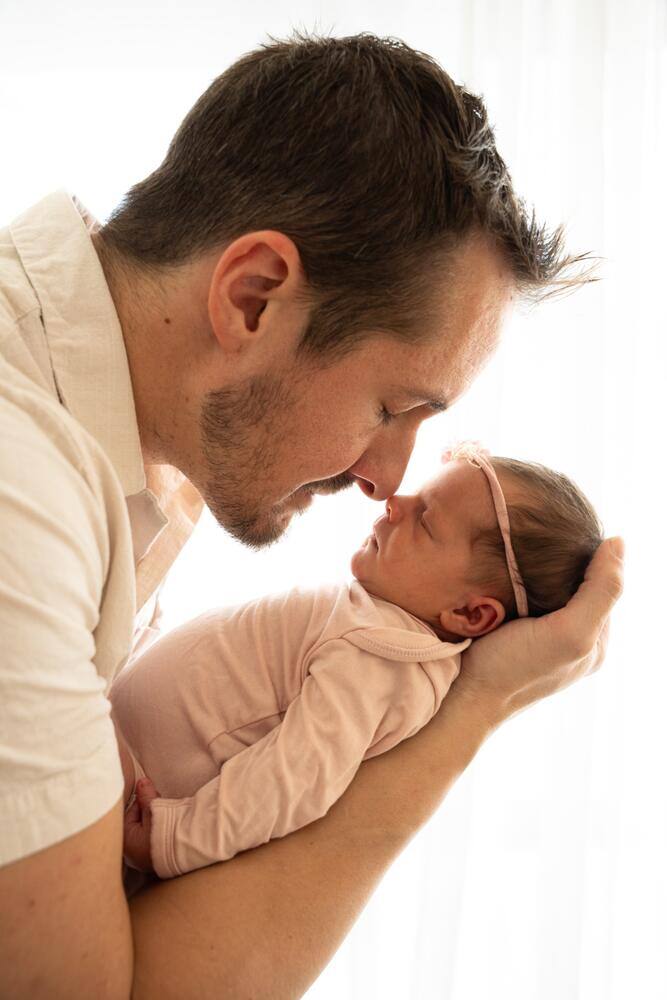 Father kissing his newborn