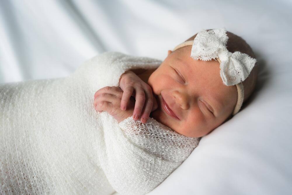 Sleeping newborn in white