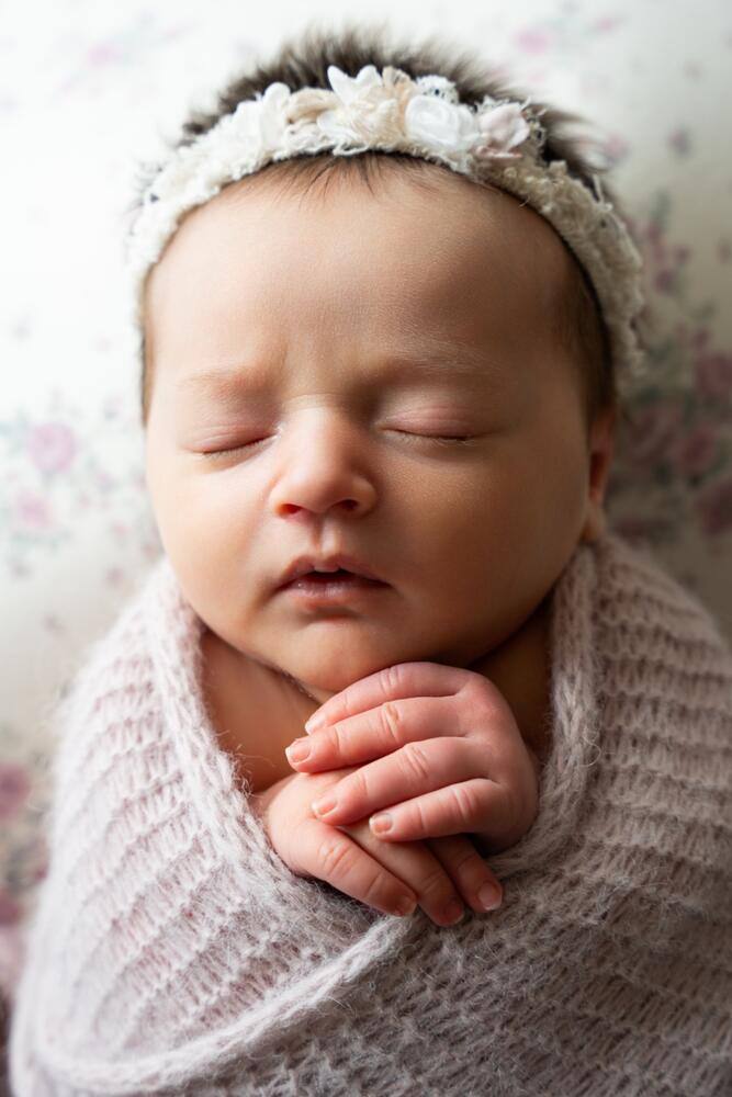 Sleeping newborn wrapped in gray