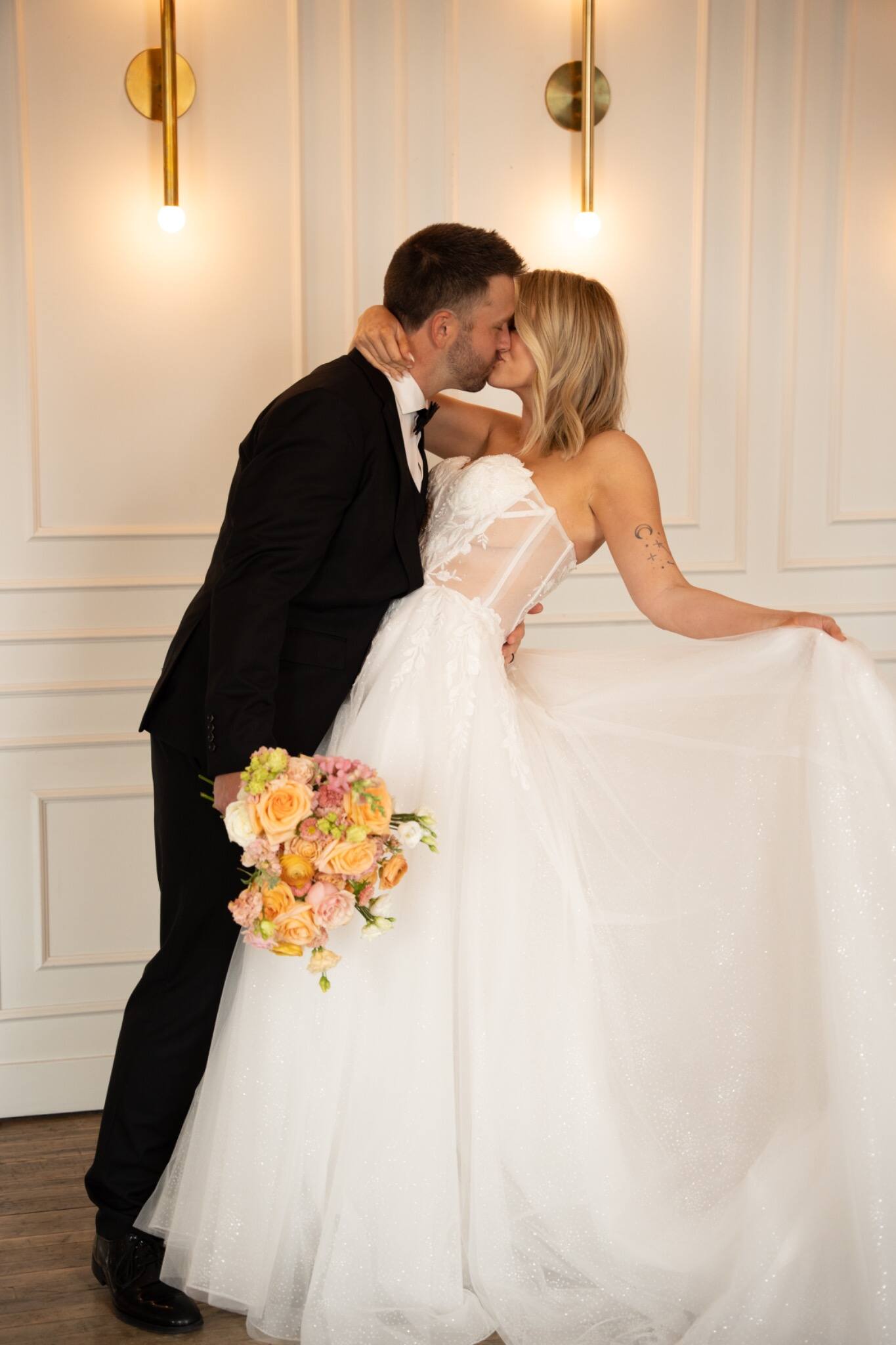 Newlyweds kissing inside their wedding venue