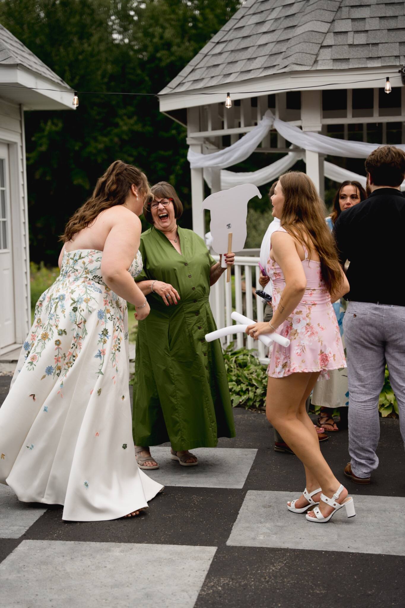 Friends dancing during an outdoor wedding reception