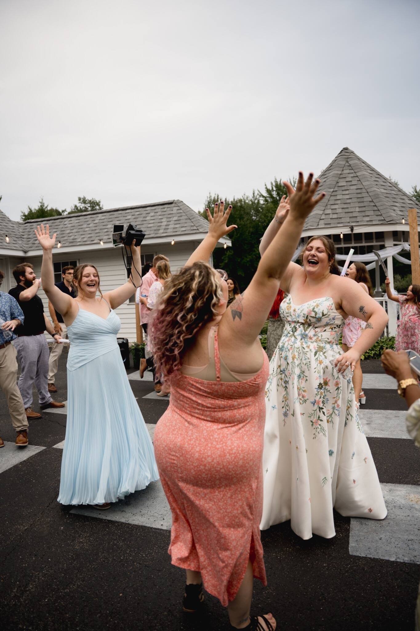 Bride and guests cheering during the reception