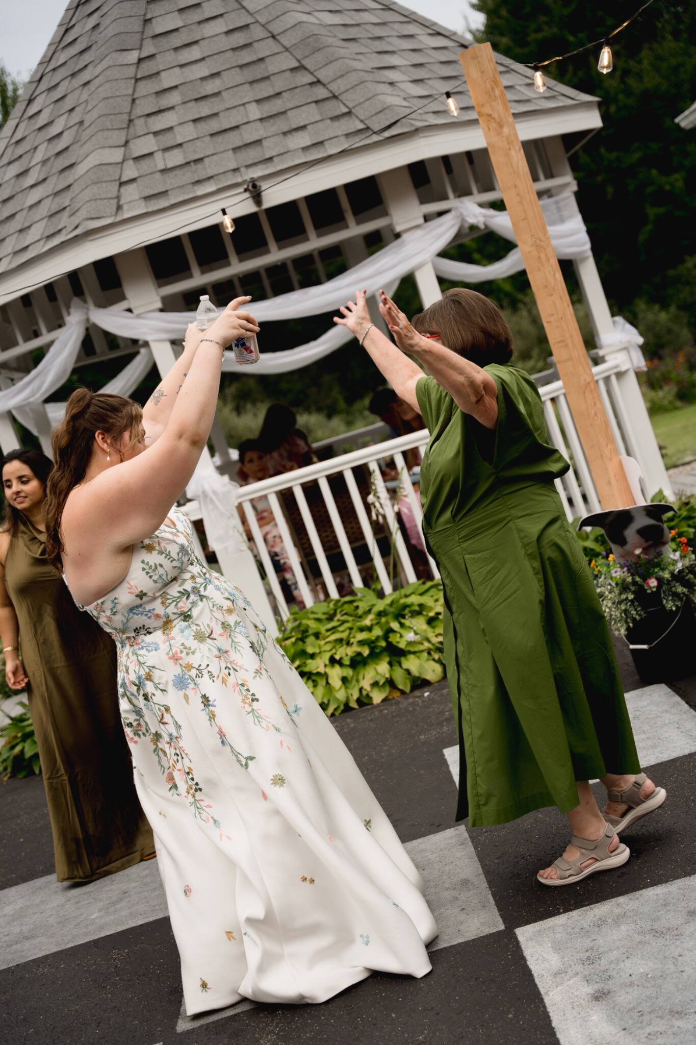 Bride dancing with a guest at her outdoor reception