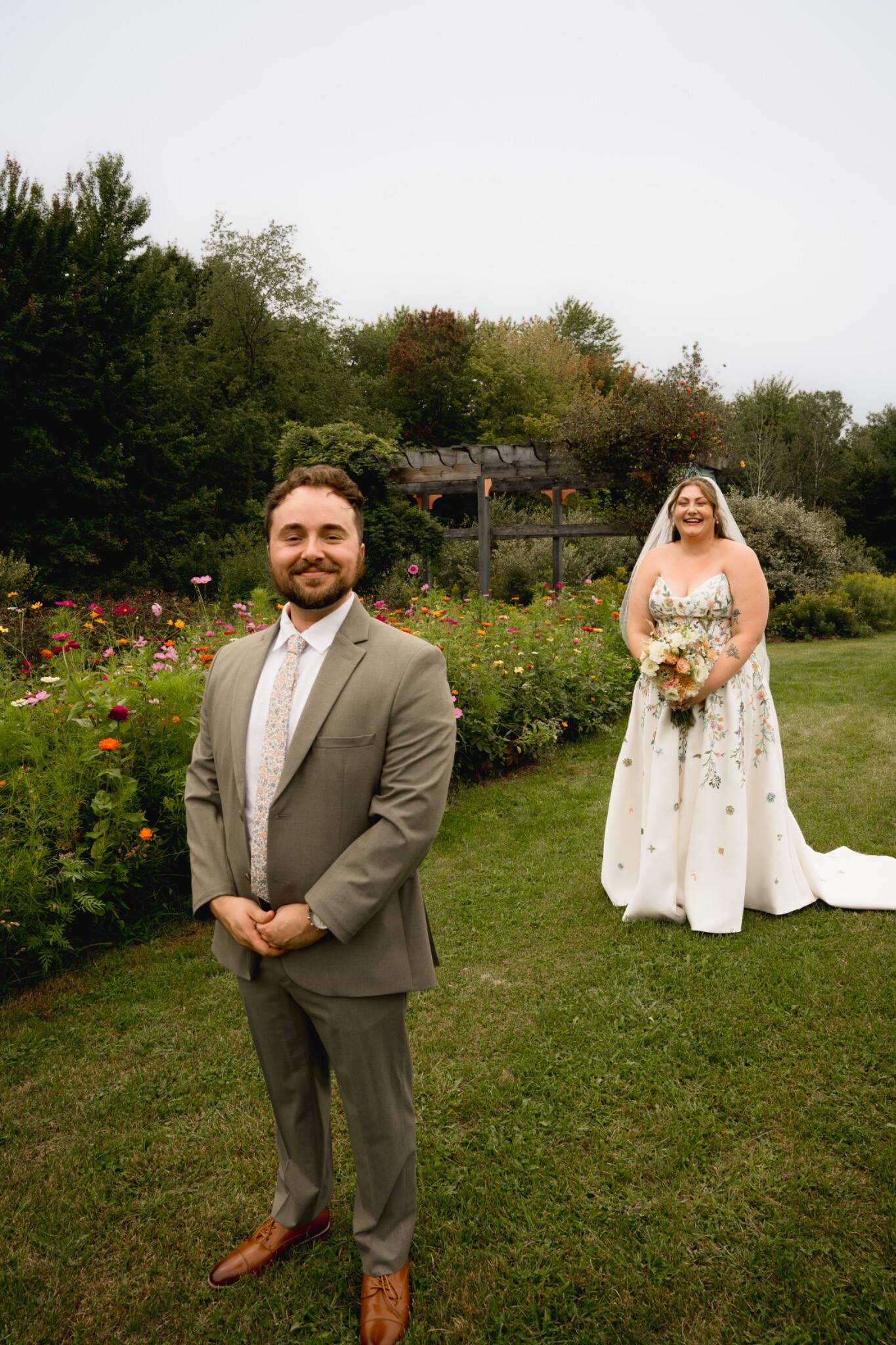 Bride approaching the groom for their garden first look