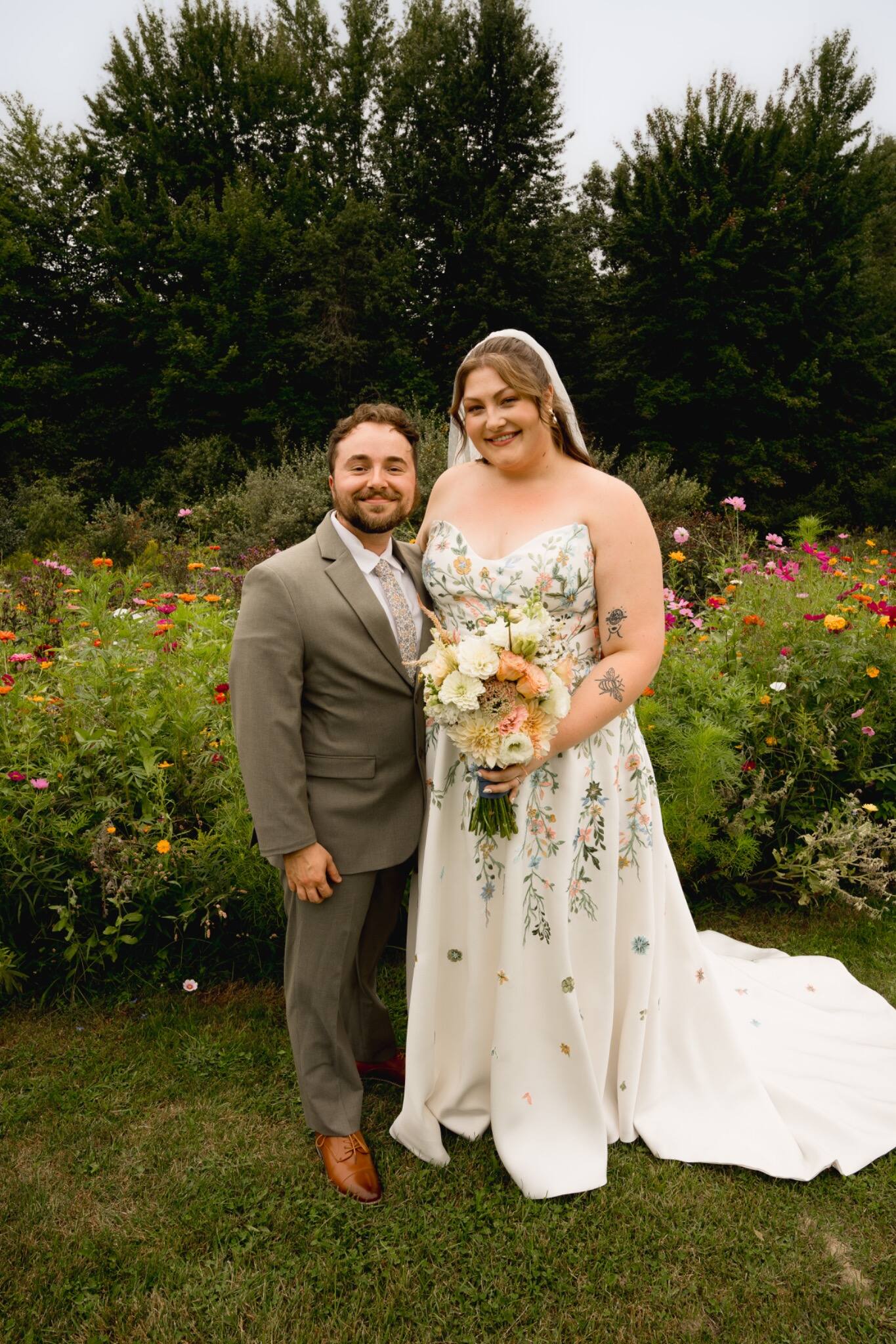 Newlyweds posing together in a flower garden