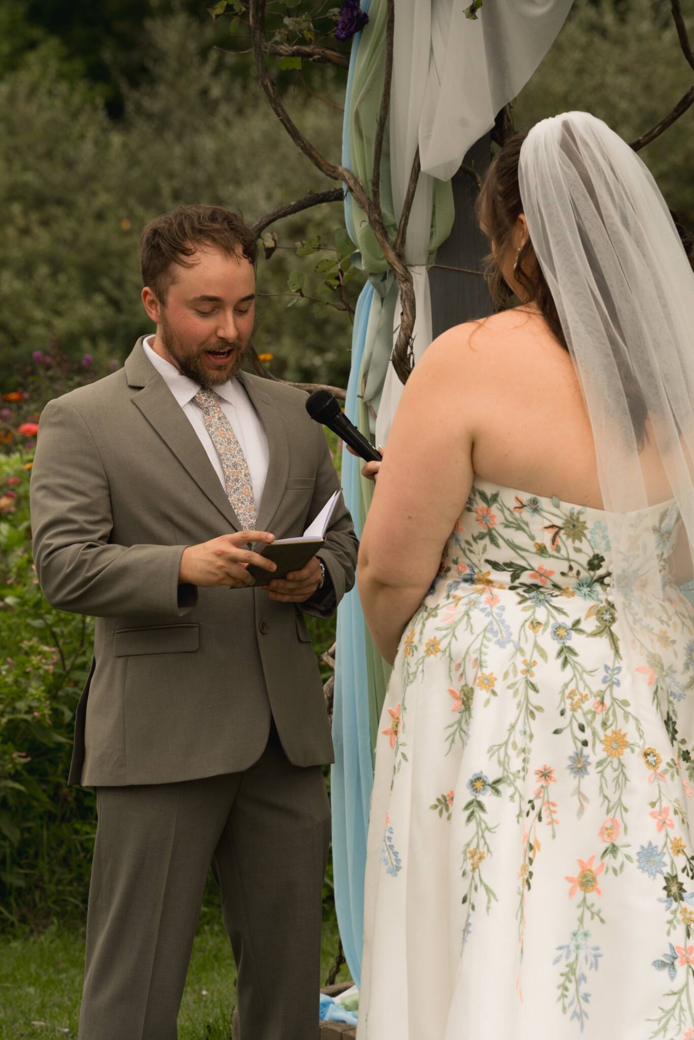 Groom reading his vows during an outdoor ceremony