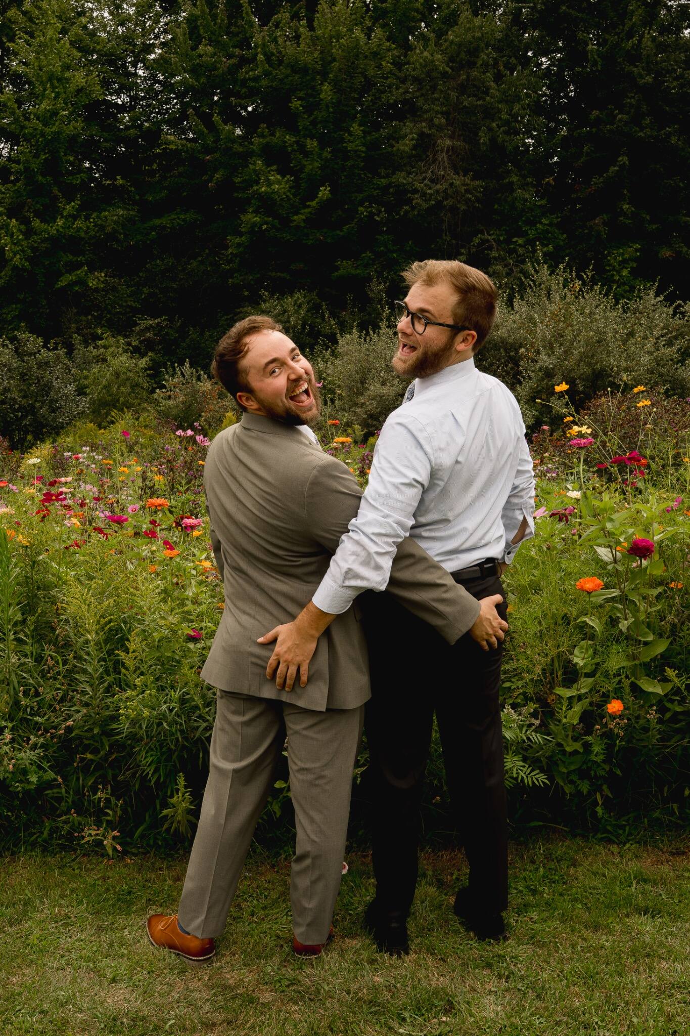 Groom sharing a playful portrait with a wedding guest