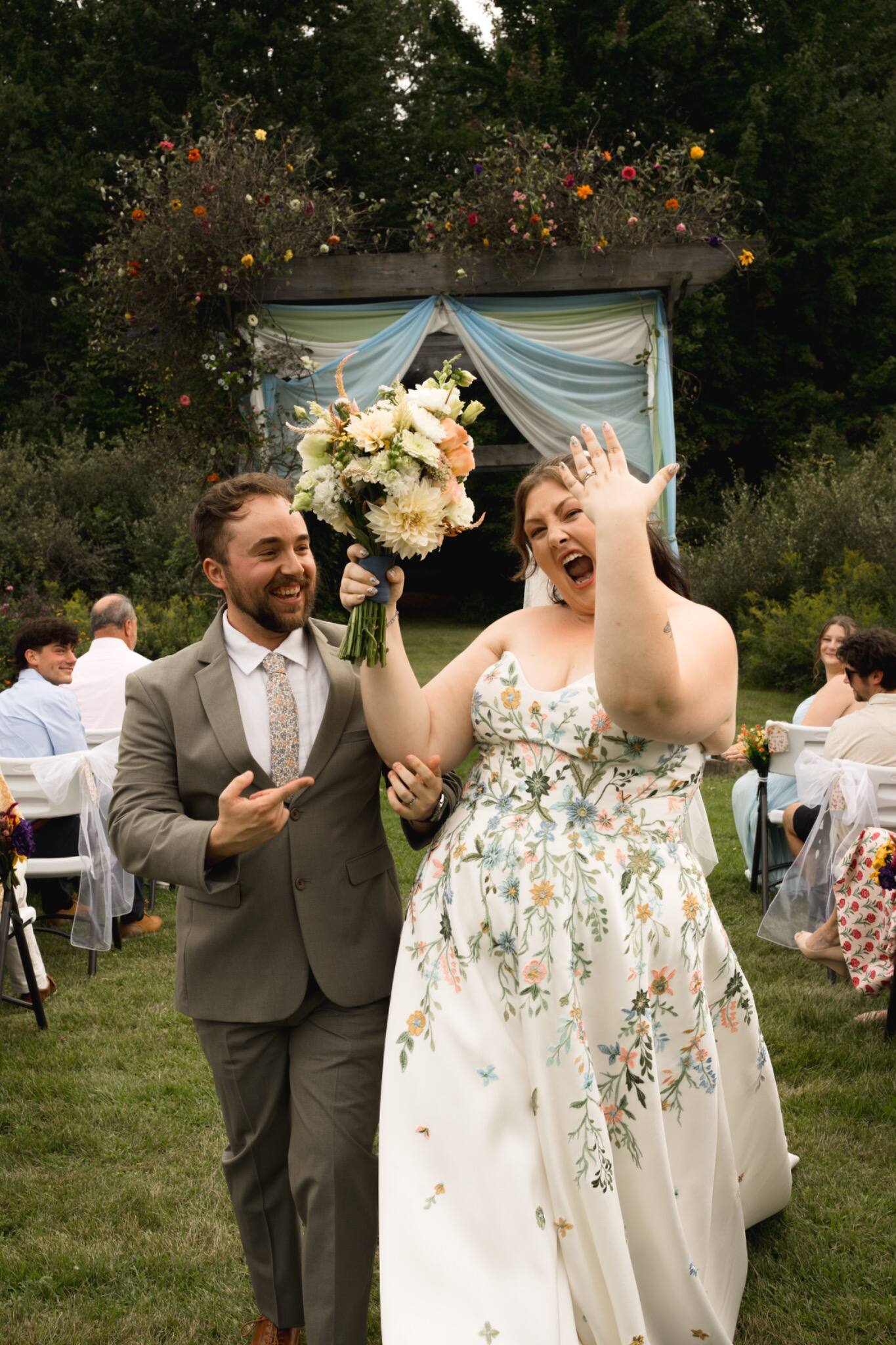 Newlyweds celebrating beneath a tossed bouquet