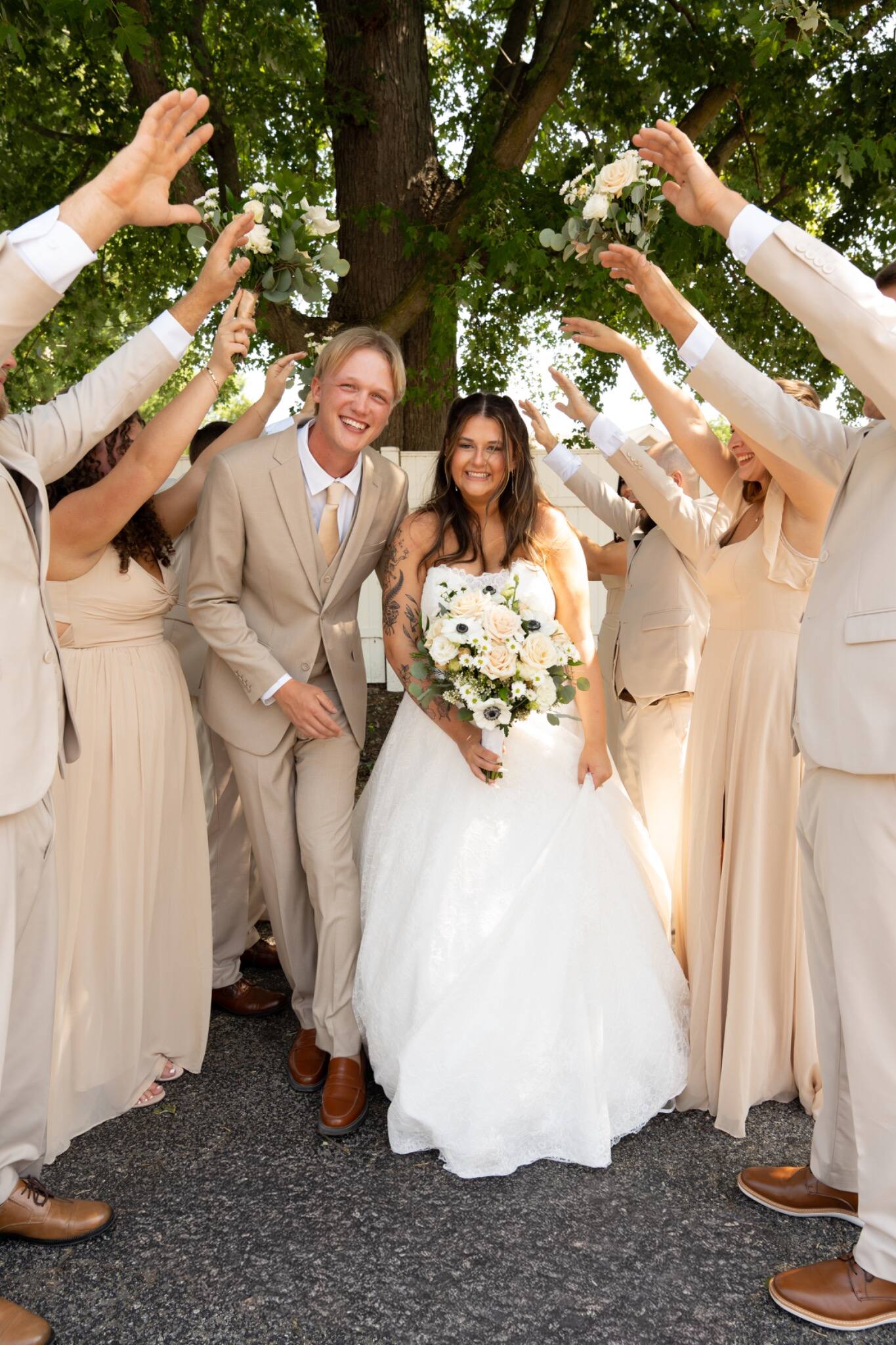 Newlyweds walking through a cheering wedding party