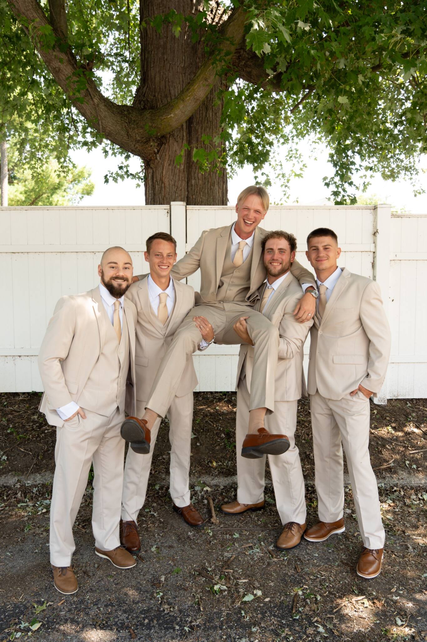Groom and groomsmen sharing a playful portrait