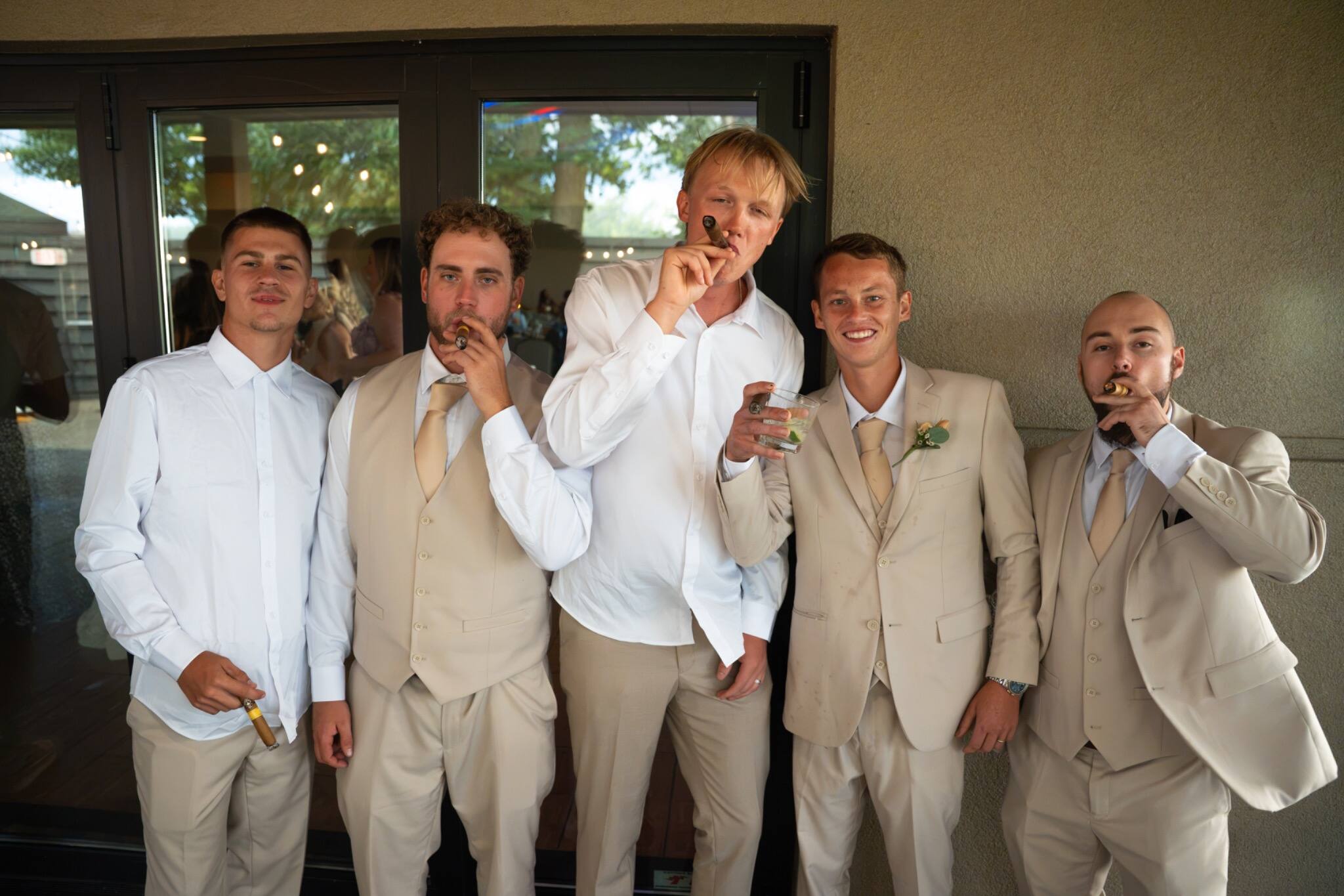 Groomsmen celebrating together during the reception